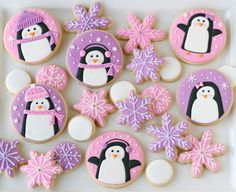 decorated cookies in the shape of penguins and snowflakes