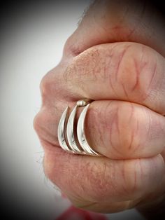 a person's hand with three rings on it