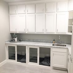 an empty kitchen with white cabinets and marble counter tops in the center, along with black and white checkered dish towels