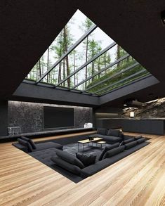 a large living room with wooden floors and skylights