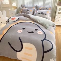 a bed with an elephant comforter and pillows