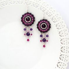 "I created this purple earring by hand, using Swarovski Rivoli (12mm) for each one, Swarovski 3mm beads, amethyst stone 6-4mm, Miyuki round seed beads, Miyuki Delica beads and Sterling Silver ear-wire Boho chic, striking and full of presence * Measurements: Earring length: 2.36\" (6cm) Pendant diameter: 0.78\" (2cm) * The earrings will come beautifully packaged for a gift. *Additional information on the matching necklace you can see here: https://www.etsy.com/listing/218652255/amethyst-crystal-n Handmade Purple Sterling Silver Chandelier Earrings, Czech Glass Dangle Earrings With Bead Caps, Purple Beaded Earrings As Gift, Purple Beaded Round Earrings For Gift, Purple Round Beaded Earrings With Ear Wire, Purple Round Beaded Earrings For Gift, Crystal Round Earrings With Ear Wire, Nickel-free Purple Sterling Silver Beaded Earrings, Silver Crystal Earrings With Dangling Beads