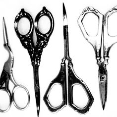 four pairs of scissors sitting next to each other