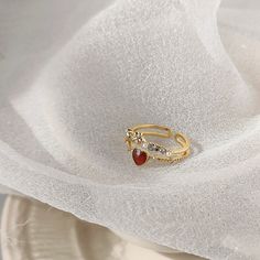 📌 Please Note: When adjusting the ring, please squeeze or expand the ring body slowly and gently. 💎 Materials: 14k Gold Electroplated Brass - more durable than regular platings Cubic Zirconia Pearlescent Beads Eco Resin 📐 Size: Adjustable Open Design - Size 6+ Heirloom Gold Ruby Ring For Valentine's Day, Ruby Heart Ring With Gemstone, Red 14k Gold Heart Ring With Gemstone, Valentine's Day Heart-shaped 14k Gold Signet Ring, Heart-shaped 14k Gold Ruby Ring For Valentine's Day, Glassine Bags, Eco Resin, Green Item, Jewelry Pouch