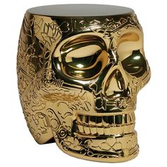 a gold colored skull mug with ornate designs on it