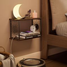 a room with a bed, lamp and books on the shelf in front of it