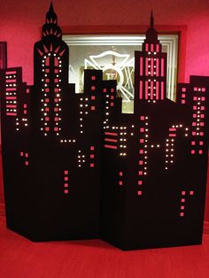 an image of a city scene made out of paper with red and black lights on it