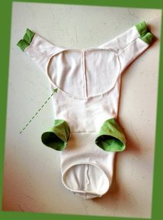 a white bodysuit with green leaves on it