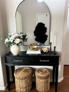 a black table with two stools and a mirror