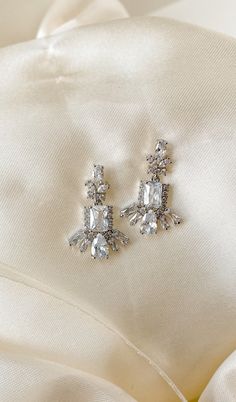 These earrings are the perfect subtle statement design! The high end details are perfect for that little extra pop of sparkle. Sophisticated and controlled in design, they are the perfect take on the modern classic baguette shapes. This earring is versatile in design - it is perfect for a gown from art-deco style to modern. The earrings are more delicate in size, but the design holds the impact. Silver Baguette Cut Diamond Earrings For Formal Occasions, Formal Bridal Earrings With Baguette Diamonds, Silver Baguette Cut Diamond Bridal Earrings, Formal Platinum Baguette-cut Earrings, Dazzling White Baguette-cut Earrings, Nye Wedding, Gorgeous Earrings, Bridal Earrings, Crystal Earrings