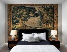 a bedroom with a large tapestry on the wall and two nightstands next to it