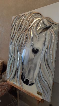 a glass sculpture of a horse with long manes on it's head is shown