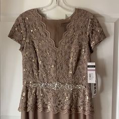 Short Sleeve Taupe Stretch Lace V-Neck Bodice With Stretch Mesh Skirt And Beaded Waist Detail. Brand New. Never Worn. 100% Polyester; 64% Nylon, 34% Polyester, 2% Spandex Imported Hand Wash Short Sleeve Gown With Full Skirt Gown With Short Sleeves Fitted V-neck Maxi Dress For Mother Of The Bride, Gown With Short Sleeves, Short Sleeve Gown, Sleeve Gown, Mesh Skirt, Gowns With Sleeves, Lace Gown, Stretch Lace, Full Skirt