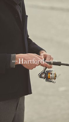 a man holding a fishing rod and spinning it