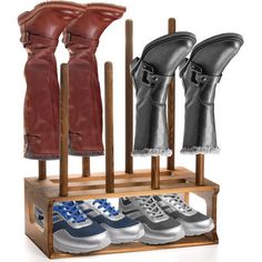 three pairs of shoes are in a shoe rack with leather gloves hanging on the racks