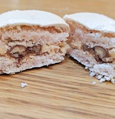 a half eaten pastry sitting on top of a wooden table