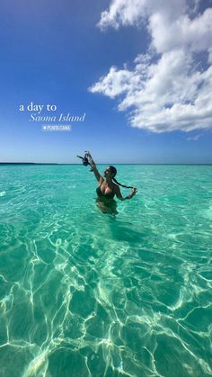 a woman swimming in the ocean with her arms outstretched