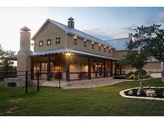 a large house with a metal roof in the evening