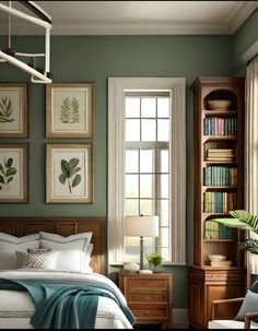 a bedroom with green walls and pictures on the wall above the bed, along with bookshelves