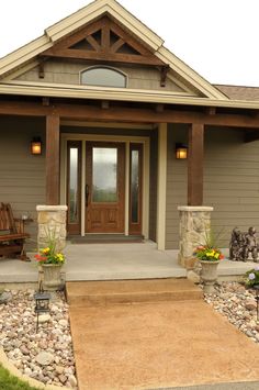 the front entrance to a home with stone and wood accents