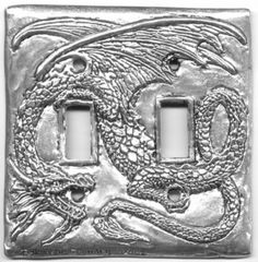 two light switch covers with an image of a dragon