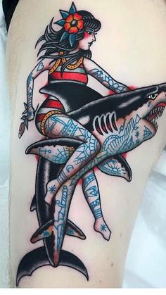 a woman is sitting on top of a shark with an arrow in her hair and tattoos