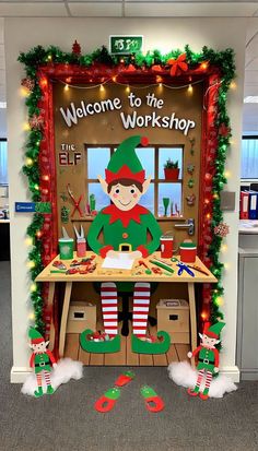 an office cubicle decorated for christmas with elfs and elves on the front desk