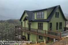 a large green house on top of a hill