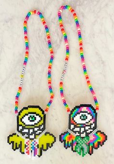 two beaded necklaces with colorful beads and an image of a character on them