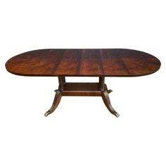 an oval dining table with two leaves on each end and one leaf at the top