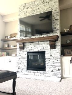 a fireplace with a flat screen tv mounted above it