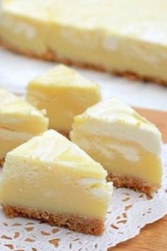 several pieces of cheesecake sitting on top of a doily