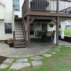 a patio with steps leading up to the deck