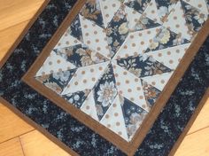 a quilted table topper with polka dots and an old fashioned star design on it