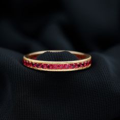 Product Details The Eternity Ring is beautifully adorned with Round Shape Ruby Gemstones in the Channel Setting. This Eternity Ring with Milgrain Detailing will be a perfect Anniversary Ring for a woman. Product Information SKU SHP-RINGS102026461 Width 1.8 mm Height 2.5 mm Weight 1.88 gm (Approximate) RUBY INFORMATION No.of Stones 34 Pieces Total Weight 2.04 Carat (Approximate) Dimension(approx) Round-2X2 mm-34 Pcs Color Red Cut Brilliant Shape Round Setting Type Channel Setting Quality Grade AAA View More Product Parent Collection Handle ruby-rings Ruby Round Cut Eternity Band, Luxury Lab-created Ruby Half Eternity Ring, Red Ruby Round Band Jewelry, Red Ruby Round Eternity Band, Gold Ruby Ring With Round Stone, Fine Jewelry, Ruby Eternity Ring, Channel Setting, Ruby Gemstone, Ring Sizer