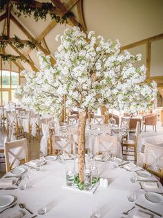 the centerpieces are arranged in clear vases with white flowers