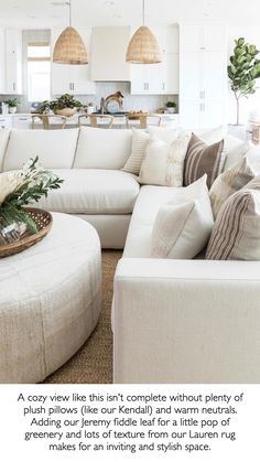 a living room filled with lots of white furniture and pillows on top of a rug