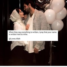 a man and woman standing next to each other with balloons in the air behind them