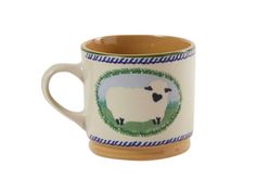 a coffee cup with a white sheep on the front and green border around it's edge