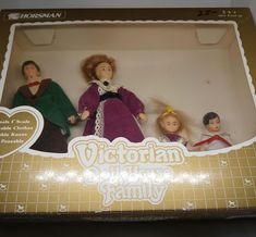 three dolls in a box with the caption victorian costume family written on one side