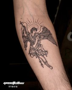 a man with a tattoo on his arm holding an angel