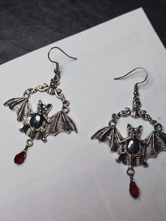 Elvira's Bat Hoop Earrings. Bat Earrings, Silver Earrings, Vintage Bat Jewelry, -Thank you for choosing us. Length - 5 cm. Width - 5 cm. CONDITION: New When placing an order, please write your phone number, this is required by the transport company. Thank you.  ❤︎ Click here to visit my store ❤︎ Dark Beauty:  https://www.etsy.com/shop/DarkBeauty8?ref=seller-platform-mcnav Bat Hoop Earrings, Gothic Hoop Earrings For Pierced Ears, Gothic Hoop Single Earring, Gothic Pierced Hoop Earrings As Gift, Gothic Hoop Earrings As A Gift, Gothic Hoop Earrings For Gift, Silver Gothic Hoop Earrings As Gift, Gothic Round Earrings As Gift, Novelty Metal Earrings With Ear Wire