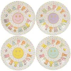 four plates with smiley faces on them and the words happy birthday written in different languages