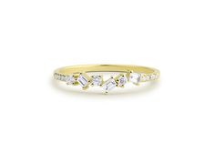 a yellow gold ring with three diamonds on the side and one diamond in the middle