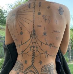 the back of a man with tattoos on his body