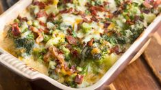 a casserole dish with broccoli, bacon and cheese in it on a wooden table