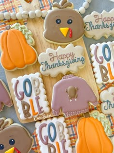 decorated thanksgiving cookies with turkeys, pumpkins and more are on a tablecloth