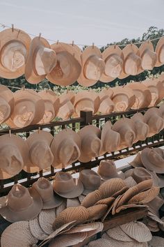 many hats are hanging up on a rack