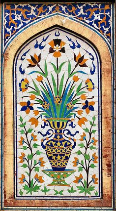 an intricately decorated wall with flowers and leaves