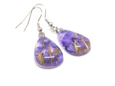 pair of earrings with purple flowers on them